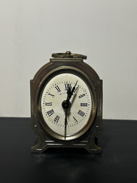 Antique metal alarm clock - an elegant tabletop piece with period elegance
